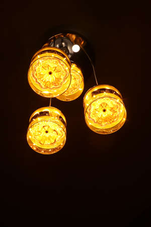 photo of a bright orange-yellow lantern in the night taken at low light in the dark having depth of...