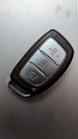 a vehicle keyless entry smart remote key with buttons for different locking and unlocking functions
