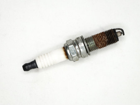 closeup of an old used rusty copper spark plug which is a component in internal combustion engines...