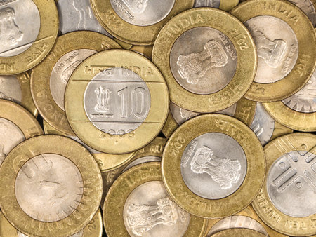 a mixed collection of rare vintage indian bimetallic 10 (ten) rupee coins gold and silver in a pileの写真素材