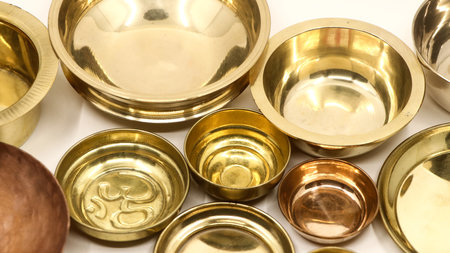 closeup of old antique gold bowl plates used in a luxury kitchen isolated in a white backgroundの写真素材