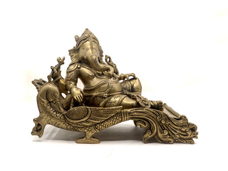 antique golden statue of elephant headed god lord ganesh sitting on a peacock throne isolated in a white backgroundの写真素材