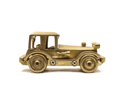 antique toy model of a vintage car made in golden metal isolatedの写真素材