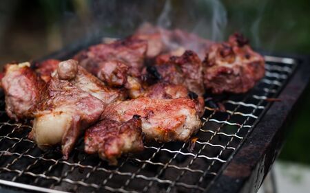 Grilled pork meat on the small grill.の写真素材