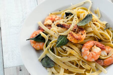 Fettuccini with shrimps and fresh basil leavesの写真素材