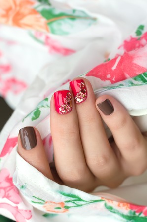 Woman hand with bright pink and gray nail artの写真素材