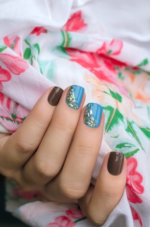 Woman hand with light blue and gray nail artの写真素材