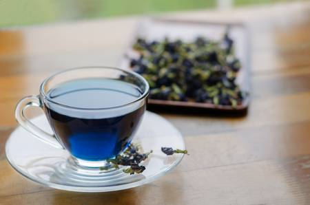 Glass cup of  blue flower tea and dried flowersの写真素材