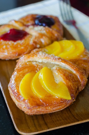 Sweet flaky pastry with mango and cherry jamの写真素材