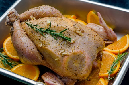 Whole chicken with oranges prepared for cookingの写真素材
