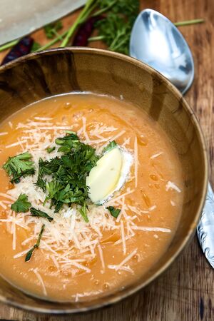 Cream soup with pumpkin, parmesan cheese and herbs.の写真素材