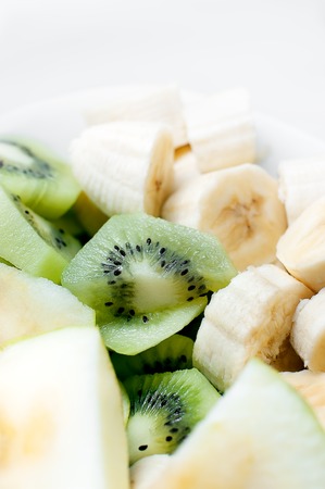 Fresh fruit in white plate. Close up.の写真素材