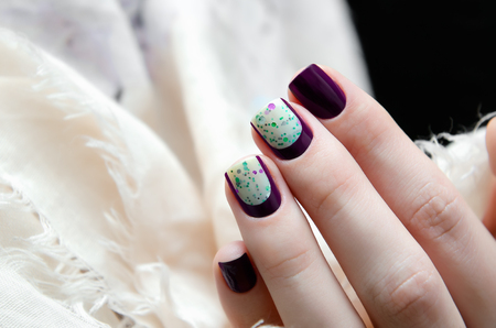 Closeup photo of woman hand with dark nail designの写真素材