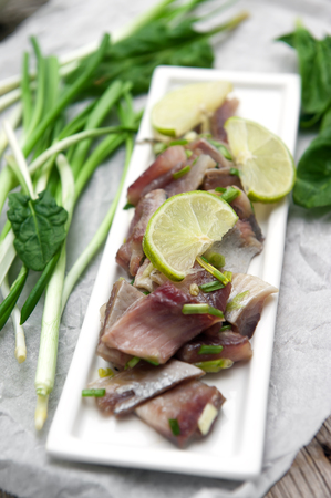 Appetizer of spicy herring with lime and onion.の写真素材