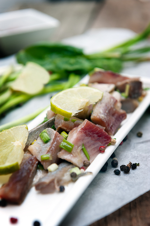 Appetizer of spicy herring with lime and onion.の写真素材