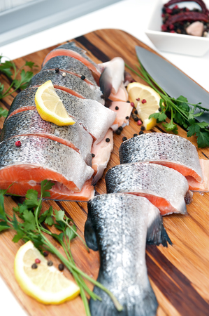 Fresh trout with lemon, pepper and parsley prepared for cookingの写真素材