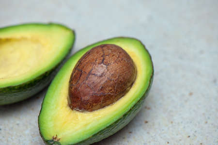 Avocado on light background. Closeup photo and selective focus
