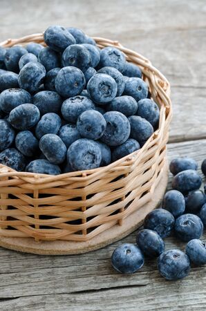 Freshly picked blueberries in wooden bowl. Blueberry on wooden Background.の写真素材