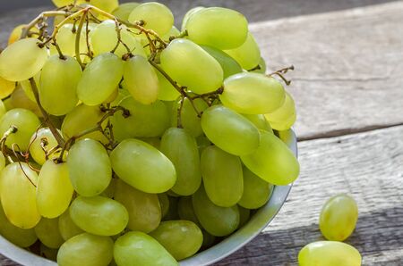Freshly picked white grapes on wooden background.の写真素材