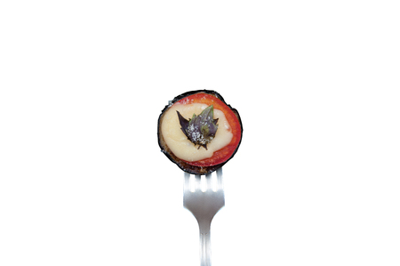 Baked eggplant with tomato, cheese and basil on a fork. Isolated on white with savedの写真素材