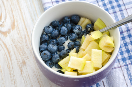 Healthy breakfast - yogurt with blueberry, oatmeal and apple.の写真素材