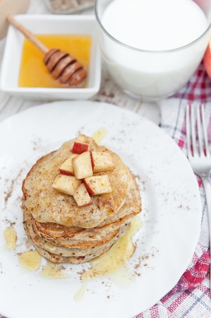 Oatmeal pancakes with apple and honey. Healthy breakfast.の写真素材