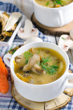 Mushroom soup with dill in white plate.の写真素材