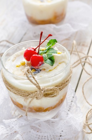 Sweet dessert with cream, bannanas and condensed milk in a glass.の写真素材