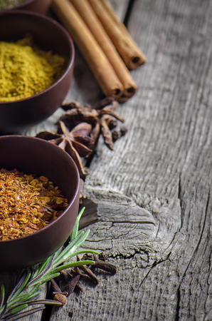 Spices on wooden background. Red pepper, curry, fennel and otherの写真素材