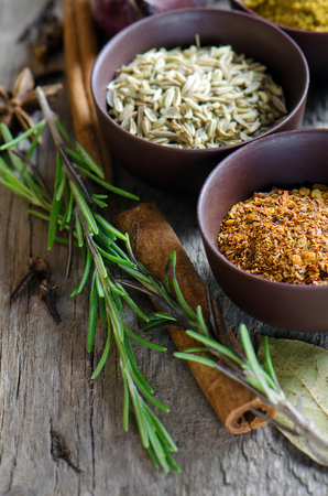 Spices on wooden background. Red pepper, curry, fennel and otherの写真素材