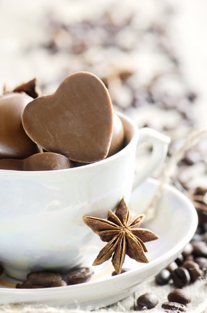 Chocolate heart and coffee beans in white cup. Happy Valentine's Day.の写真素材
