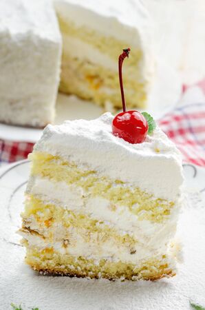 Piece of coconut cake on white plate. Close up.の写真素材