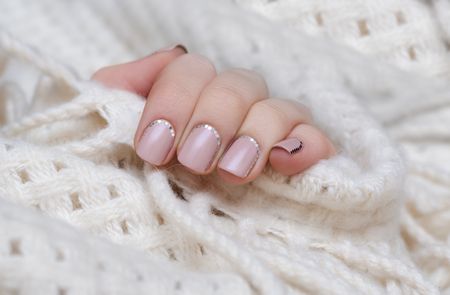 Female hand with natural pink nail design.の写真素材