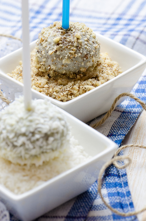 Chocolate cakepops with nuts and coconut flakes. Close up.の写真素材
