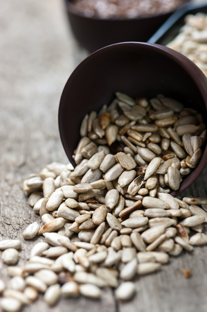 Peeled sunflower seeds on wooden table. Close up photo.の写真素材