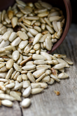 Peeled sunflower seeds on wooden table. Close up photo.の写真素材