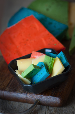Cheese Mix. Gouda, blue, green and red cheese on wooden background.の写真素材
