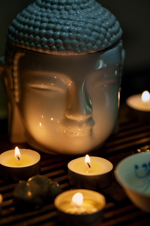 Buddha and candles, Chinese tea ceremony. Vertical orientationの写真素材