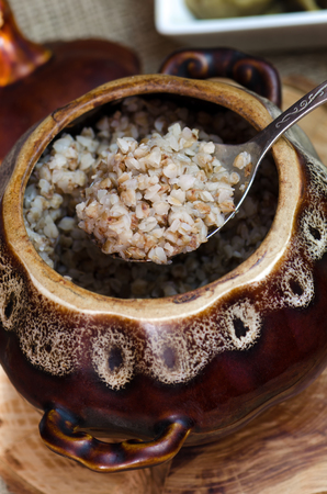 Cooked buckwheat in a brown clay pot.の写真素材