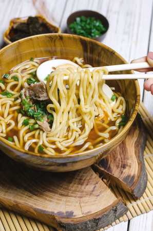 Ramen noodles with eggs, meat and green onion.の写真素材