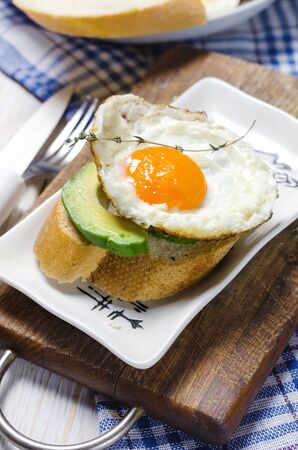 Healthy breakfast. Sandwich with rye bread, avocado and fried eggs.の写真素材