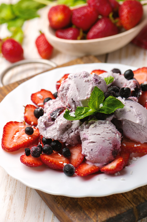 Ice cream with wild berries, strawberries and mint.の写真素材