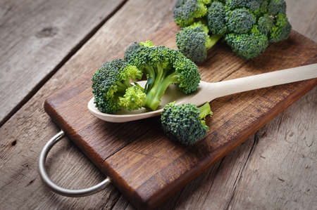 Fresh broccoli on wooden table close up.の写真素材