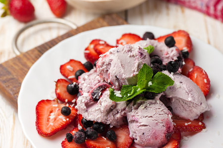 Ice cream with wild berries, strawberries and mint.の写真素材