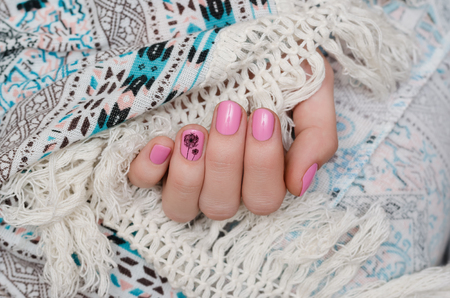 Nail art. Beautiful female hand with warm pink manicure.の写真素材