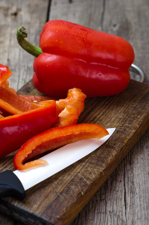 Fresh sweet peppers on wooden cutting board.の写真素材