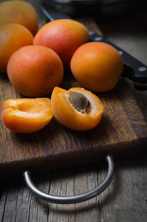 Delicious ripe apricots on wooden cutting board.の写真素材