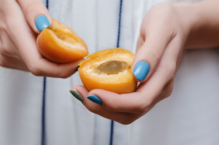 Delicious ripe apricots in female hands. Close up.の写真素材