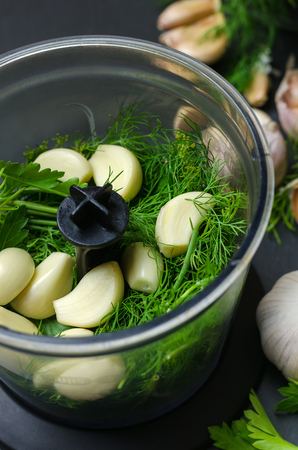 Ingredients for raw green sause with garlic, dill and parsley.の写真素材