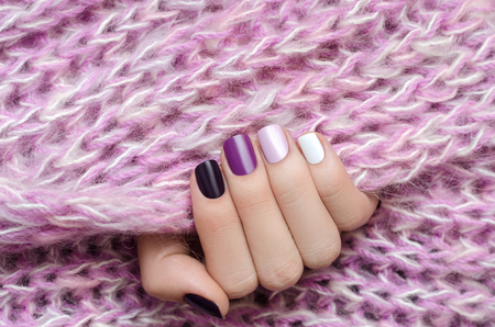 Purple nail design. Beautiful female hand with different shades of purple manicure.の写真素材